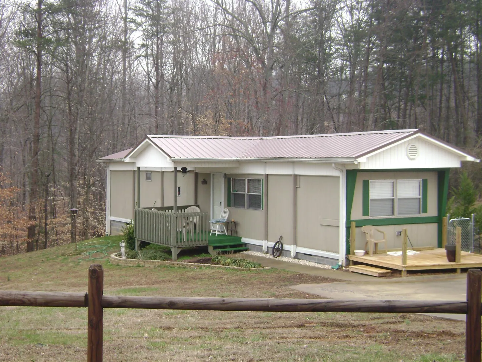 Mauve metal roof on a manufactured home with a new front deck in Masury